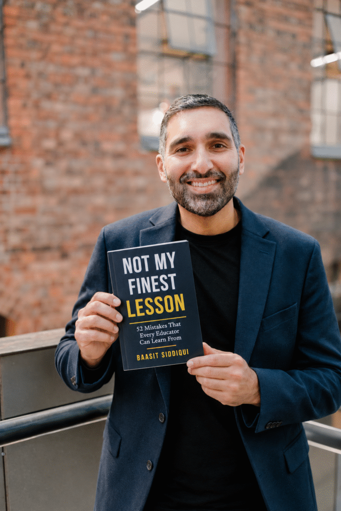 Baasit Siddiqui holding his new book Not My Finest Lesson